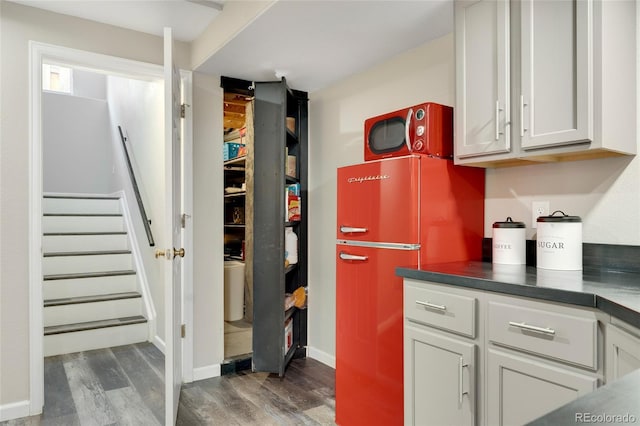 kitchen with dark hardwood / wood-style flooring and refrigerator