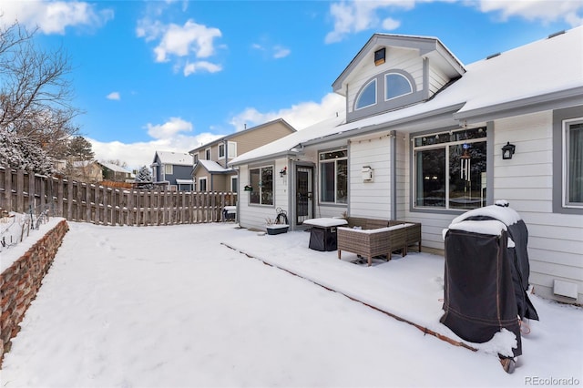 view of snow covered rear of property