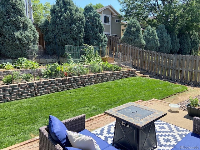 view of yard with a patio and an outdoor fire pit