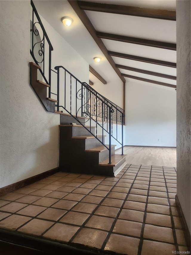 staircase featuring lofted ceiling with beams and tile patterned flooring