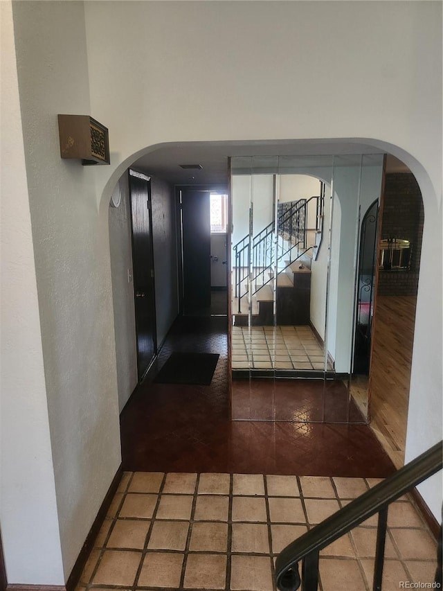 hallway with tile patterned floors