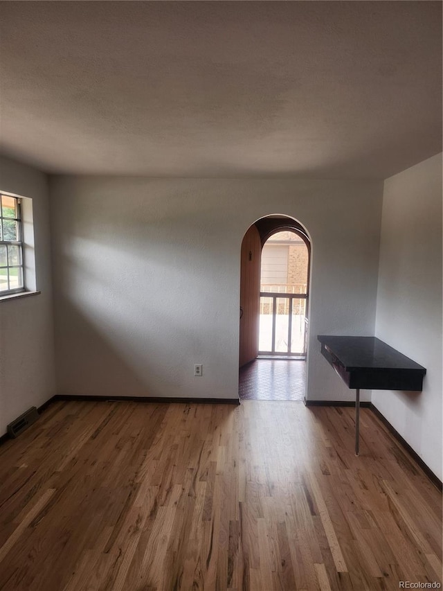 unfurnished room featuring hardwood / wood-style floors