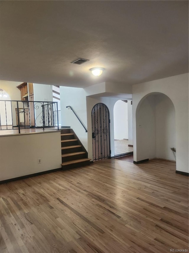 unfurnished room with wood-type flooring