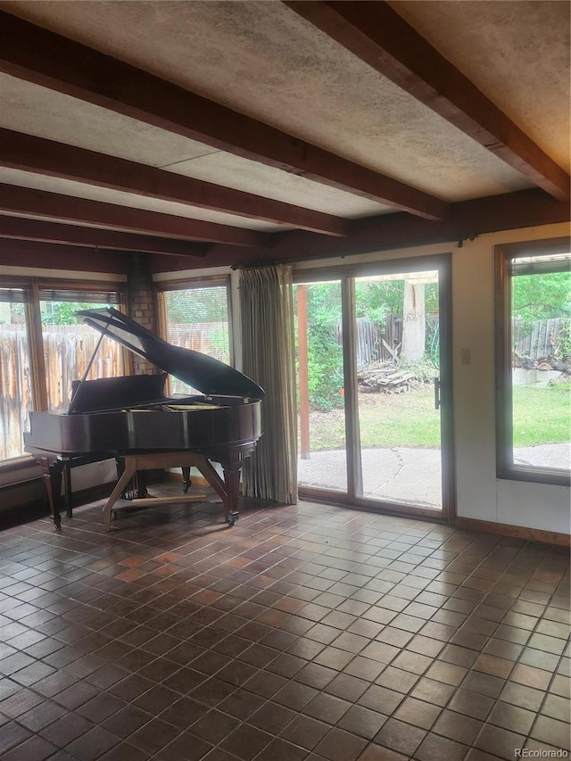 miscellaneous room with tile patterned flooring and beam ceiling