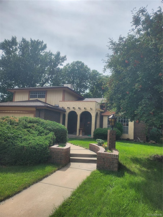 mediterranean / spanish-style home featuring a front lawn