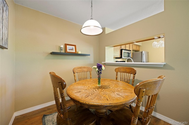 12812 Jasmine St Unit C, Thornton, CO 80602 - dining room featuring baseboards and wood finished floors
