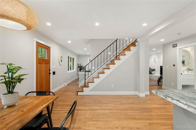 foyer entrance with light wood-type flooring