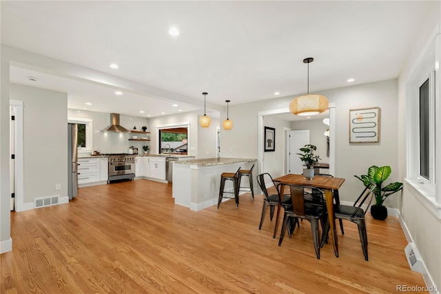 dining room featuring light hardwood / wood-style floors and sink