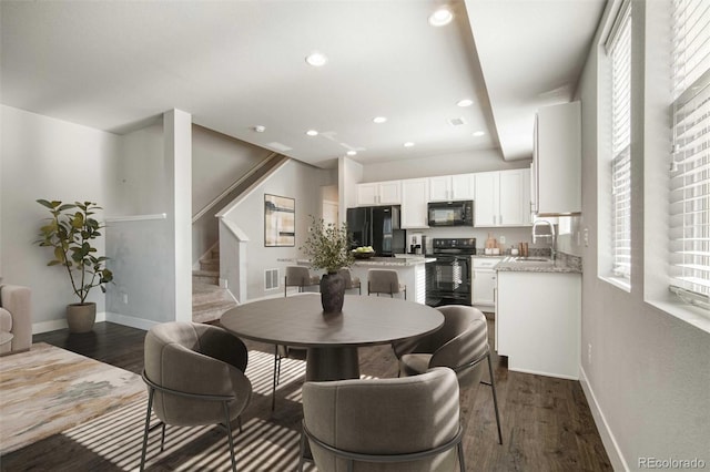 16069 E Elk Dr, Denver, CO 80239 - dining area with dark wood-style floors, stairway, and recessed lighting