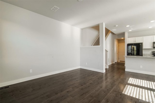 16069 E Elk Dr, Denver, CO 80239 - unfurnished living room with dark wood finished floors and recessed lighting