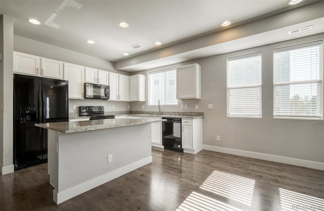 16069 E Elk Dr, Denver, CO 80239 - kitchen with black appliances, white cabinetry, a kitchen island, light stone counters, and recessed lighting
