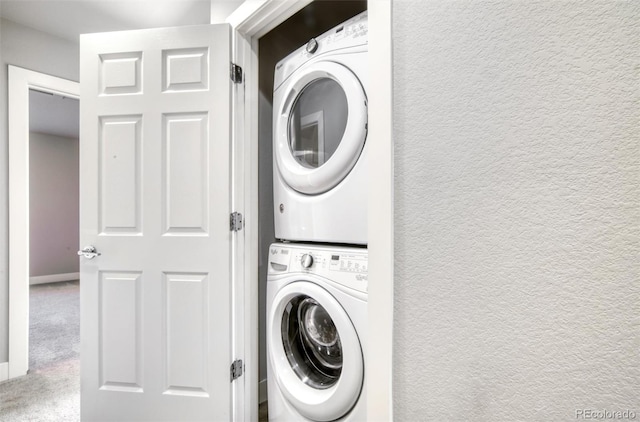 16069 E Elk Dr, Denver, CO 80239 - washroom featuring stacked washer / dryer, carpet floors, and a textured wall