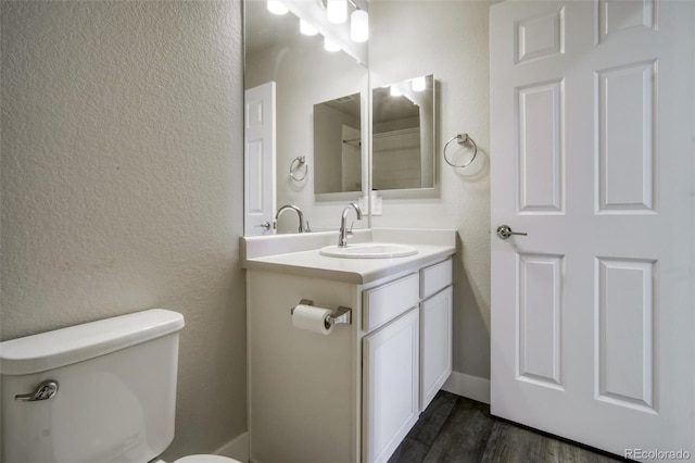 16069 E Elk Dr, Denver, CO 80239 - bathroom featuring vanity, a textured wall, and wood finished floors