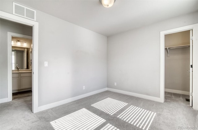16069 E Elk Dr, Denver, CO 80239 - unfurnished bedroom with carpet floors, a walk in closet, and a closet