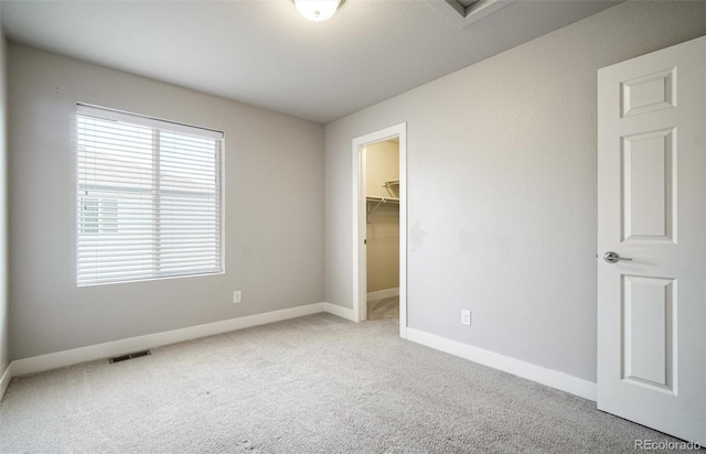 16069 E Elk Dr, Denver, CO 80239 - unfurnished bedroom with carpet flooring, a walk in closet, and a closet