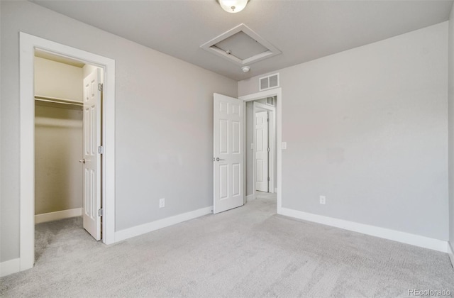 16069 E Elk Dr, Denver, CO 80239 - unfurnished bedroom with carpet, attic access, and a walk in closet
