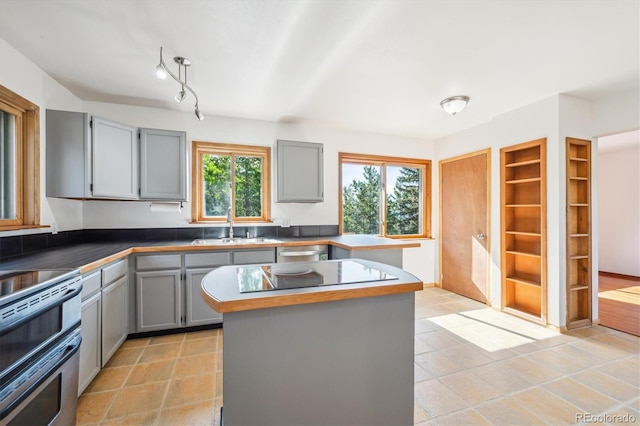 429 Overlook Dr, Bailey, CO 80421 - kitchen featuring gray cabinets, stainless steel appliances, built in shelves, a center island, and light tile patterned floors