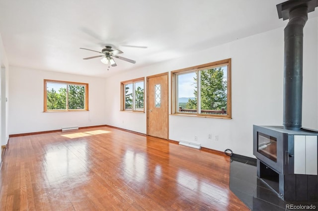 429 Overlook Dr, Bailey, CO 80421 - unfurnished living room with a wood stove, a ceiling fan, and wood finished floors
