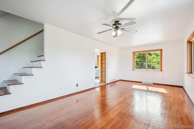 429 Overlook Dr, Bailey, CO 80421 - unfurnished living room featuring stairway, a ceiling fan, wood finished floors, and baseboard heating