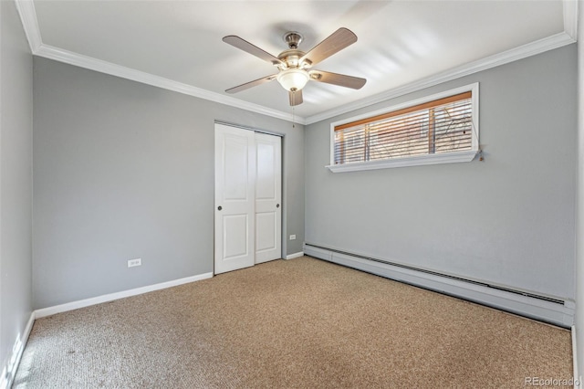 carpeted empty room with baseboards, ceiling fan, a baseboard radiator, and crown molding