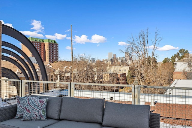 view of patio featuring a balcony and a city view