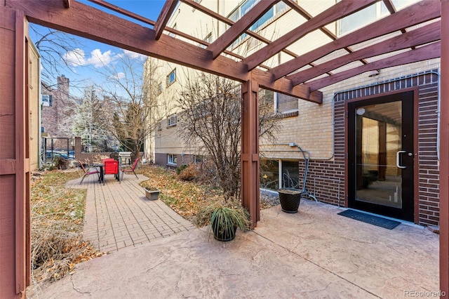 view of patio with outdoor dining space, fence, and a pergola