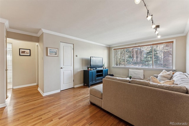 living room featuring baseboards, light wood finished floors, rail lighting, and crown molding