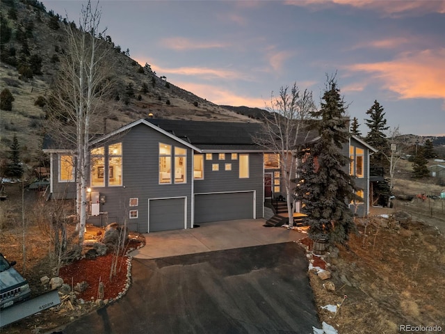 view of front facade with a mountain view and a garage