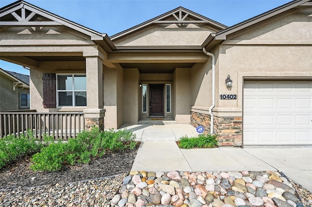 10402 Capital Peak Way, Peyton, CO 80831 - property entrance with stucco siding, stone siding, and a garage