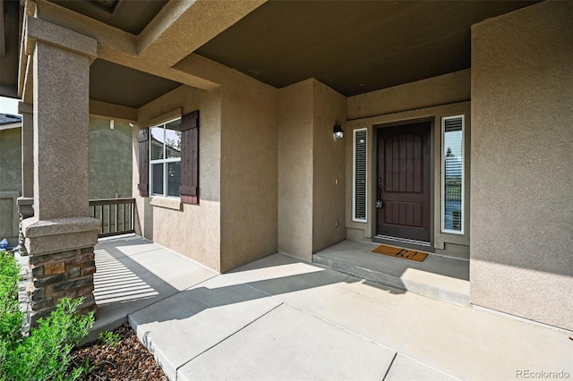 10402 Capital Peak Way, Peyton, CO 80831 - doorway to property with stucco siding and a porch