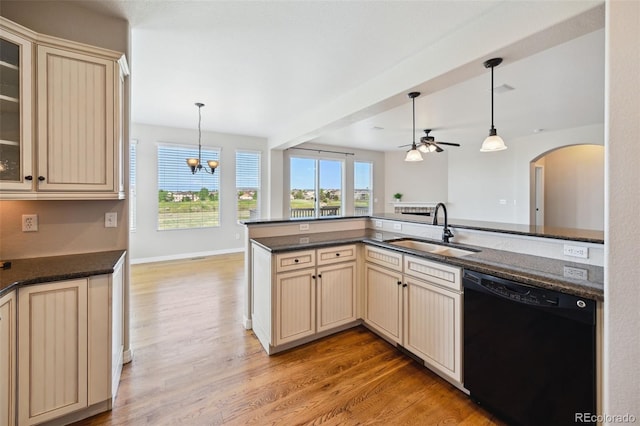 10402 Capital Peak Way, Peyton, CO 80831 - kitchen with dishwasher, cream cabinets, a sink, arched walkways, and a ceiling fan