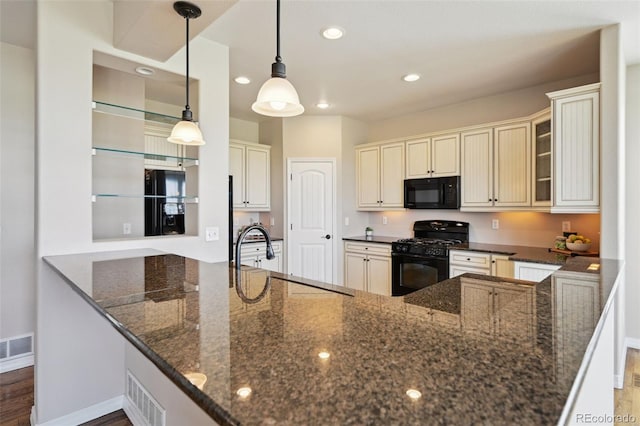 10402 Capital Peak Way, Peyton, CO 80831 - kitchen with black appliances, a sink, cream cabinetry, recessed lighting, and dark stone counters