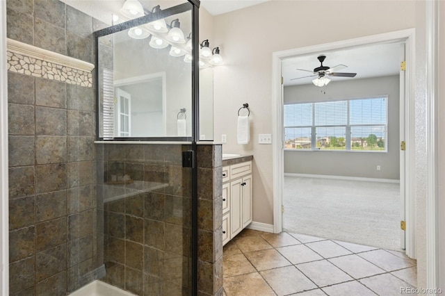 10402 Capital Peak Way, Peyton, CO 80831 - full bathroom with vanity, a ceiling fan, a shower stall, tile patterned flooring, and baseboards
