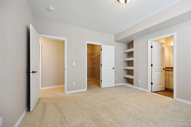10402 Capital Peak Way, Peyton, CO 80831 - unfurnished bedroom featuring carpet flooring, a spacious closet, baseboards, a closet, and ensuite bathroom