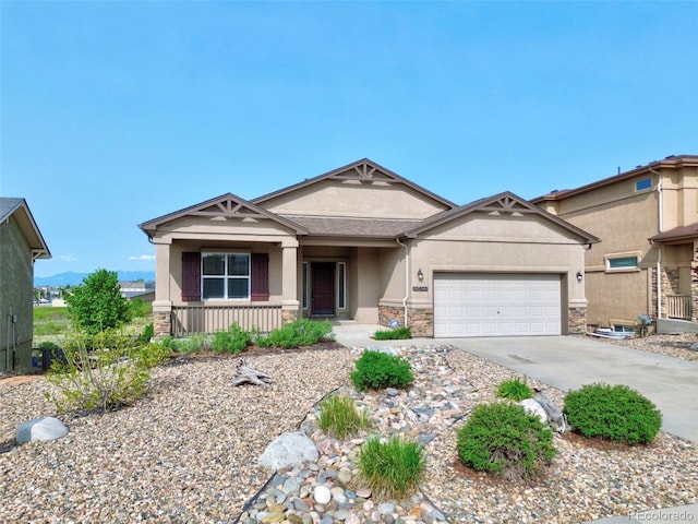 10402 Capital Peak Way, Peyton, CO 80831 - view of front of house with stucco siding, a porch, concrete driveway, an attached garage, and stone siding