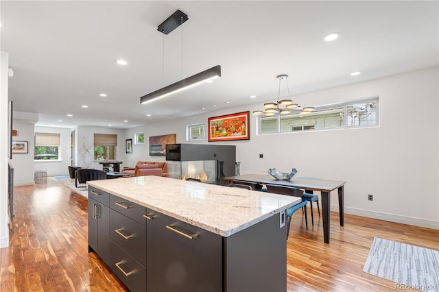 2334 Lowell Blvd, Denver, CO 80211 - kitchen featuring hanging light fixtures, light wood-type flooring, a center island, recessed lighting, and a chandelier