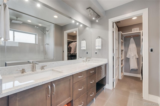 2334 Lowell Blvd, Denver, CO 80211 - bathroom featuring a spacious closet, double vanity, a tile shower, and tile patterned flooring