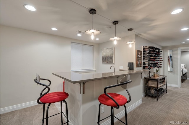 2334 Lowell Blvd, Denver, CO 80211 - kitchen featuring light colored carpet, a breakfast bar area, recessed lighting, decorative light fixtures, and a peninsula