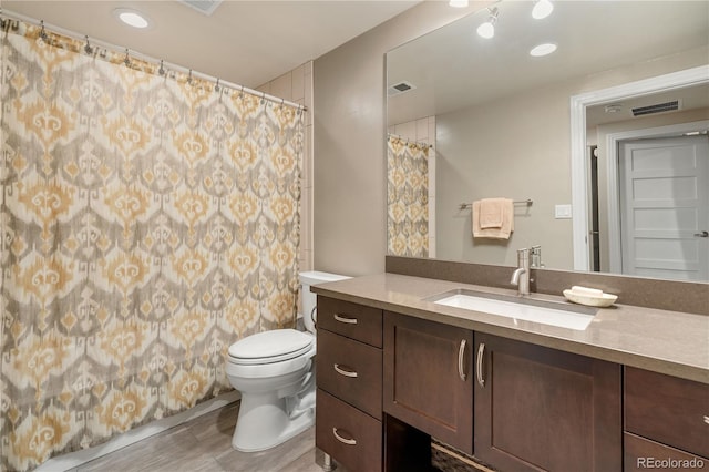 2334 Lowell Blvd, Denver, CO 80211 - full bath featuring vanity, wood finished floors, and a shower with curtain
