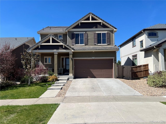 4995 S Algonquian Way, Aurora, CO 80016 - craftsman-style home with an attached garage, fence, covered porch, driveway, and board and batten siding