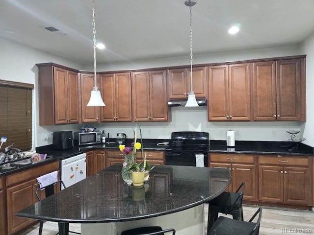 4995 S Algonquian Way, Aurora, CO 80016 - kitchen with electric range, stainless steel microwave, extractor fan, a kitchen bar, and recessed lighting