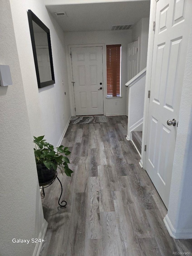 4995 S Algonquian Way, Aurora, CO 80016 - hall featuring wood finished floors, baseboards, and stairway