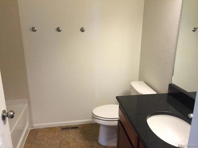 4995 S Algonquian Way, Aurora, CO 80016 - bathroom featuring toilet, vanity, baseboards, and tile patterned flooring