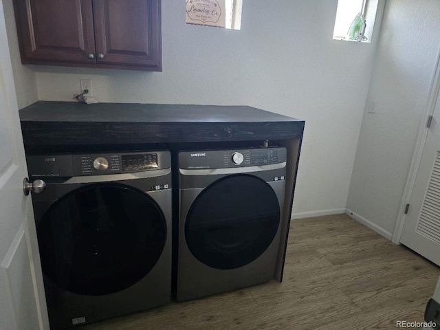 4995 S Algonquian Way, Aurora, CO 80016 - clothes washing area featuring separate washer and dryer, cabinet space, wood finished floors, and baseboards