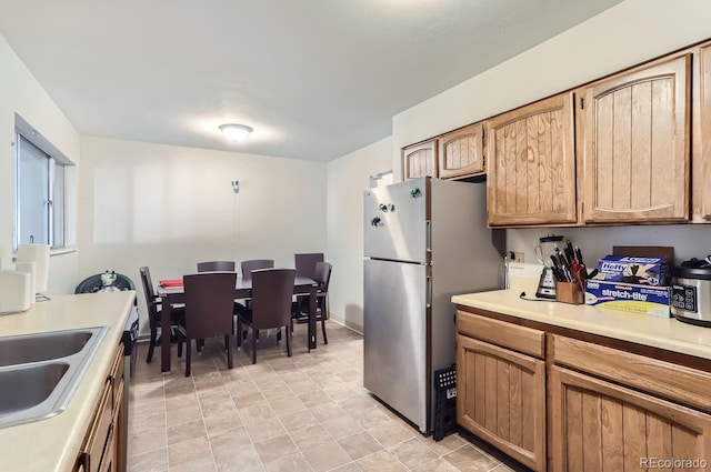 kitchen with stainless steel refrigerator and sink