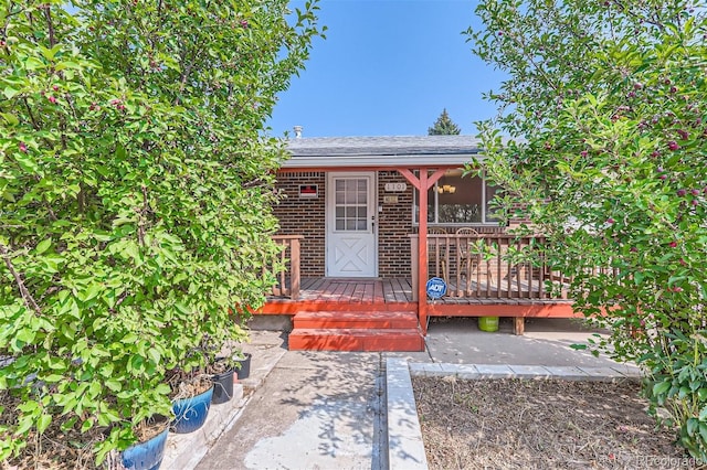 entrance to property with brick siding