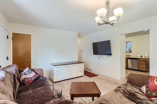 living area with a notable chandelier, baseboards, visible vents, and light colored carpet