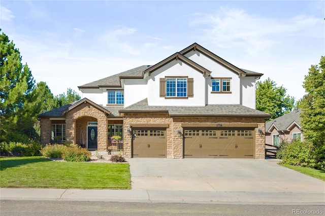 craftsman house with a garage and a front yard