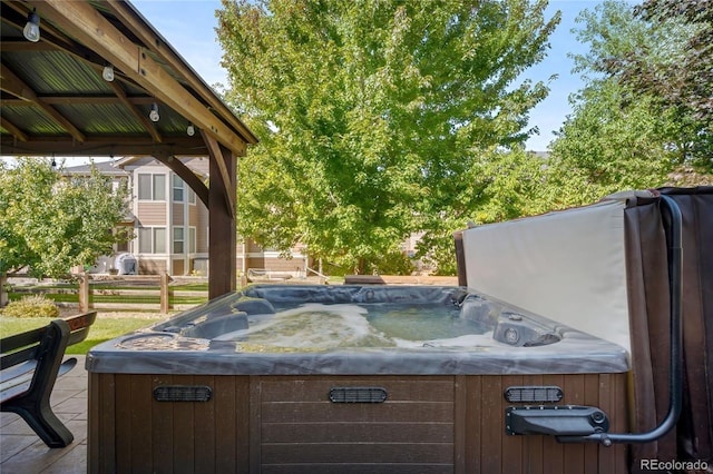 exterior space with a gazebo and a hot tub