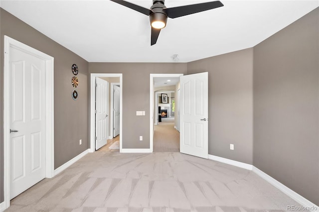 unfurnished bedroom with light carpet and ceiling fan